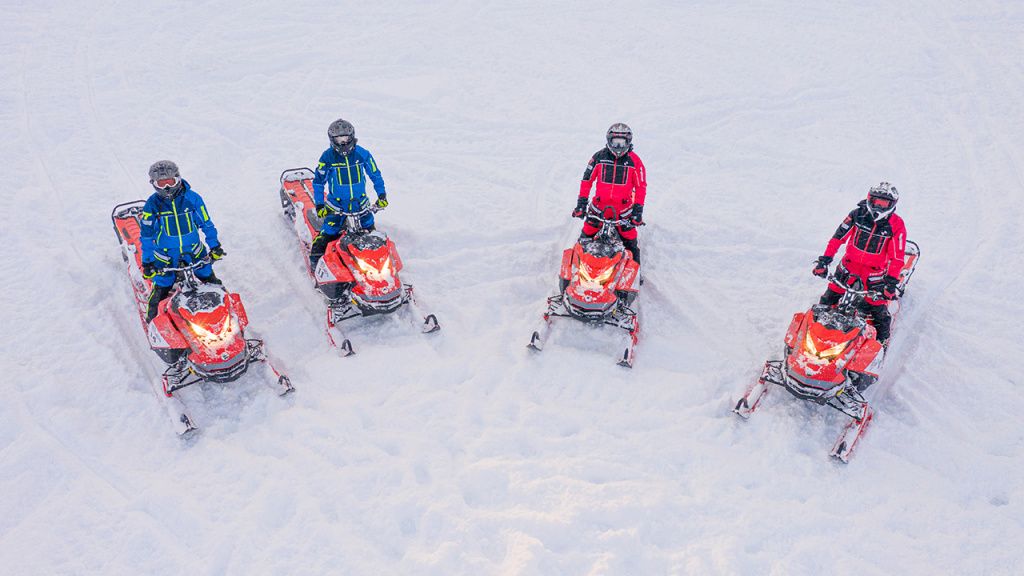 group snowmobile riding