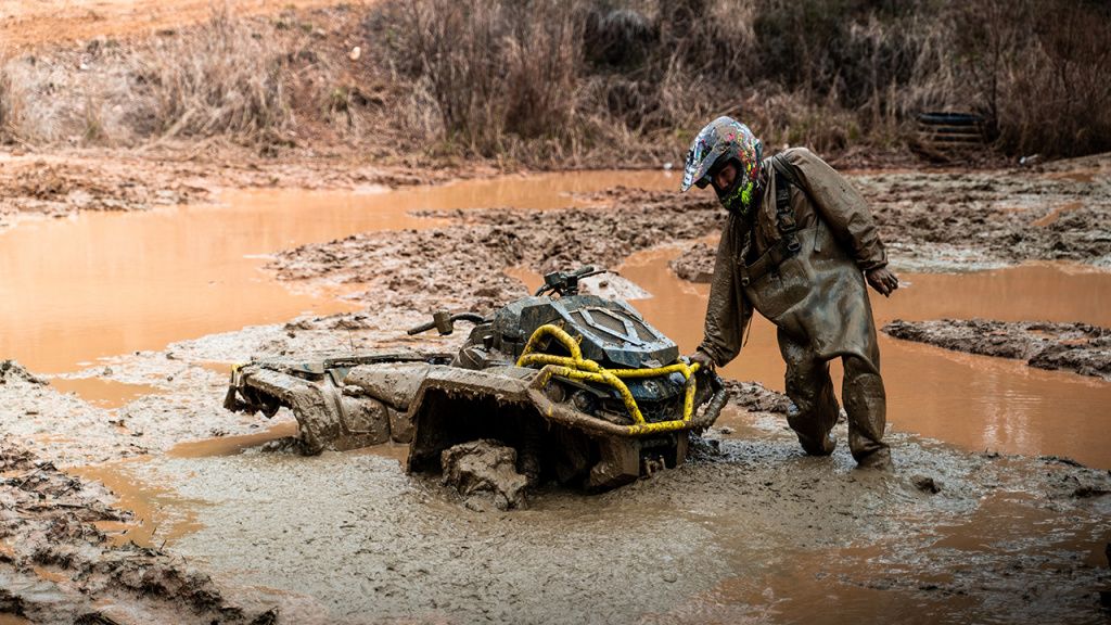 atv rider in mud in bootfoot waders in mud.jpg