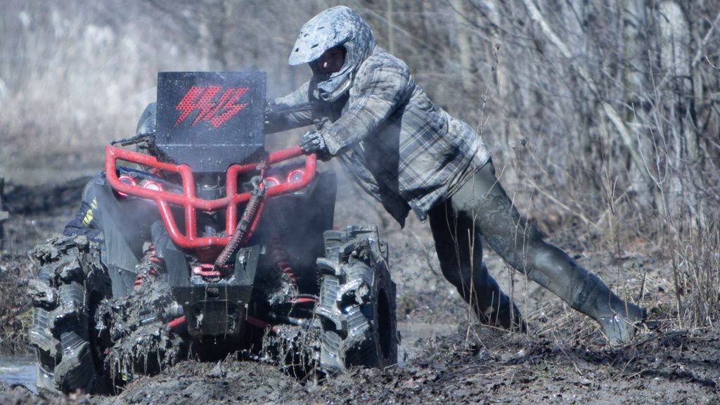 atv rider in bootfoot waders stuck in mud.jpg