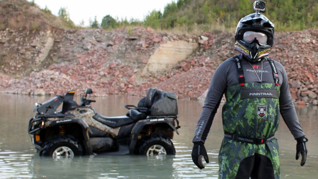 a man wearing waders and atv