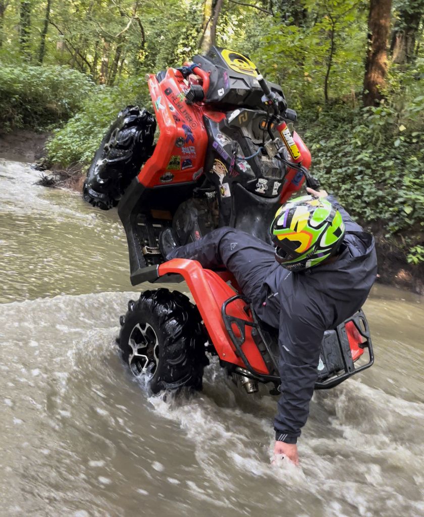 atv wheeling in rain suit