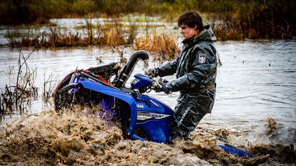 atv rider in waterproof riding gear in water.jpg