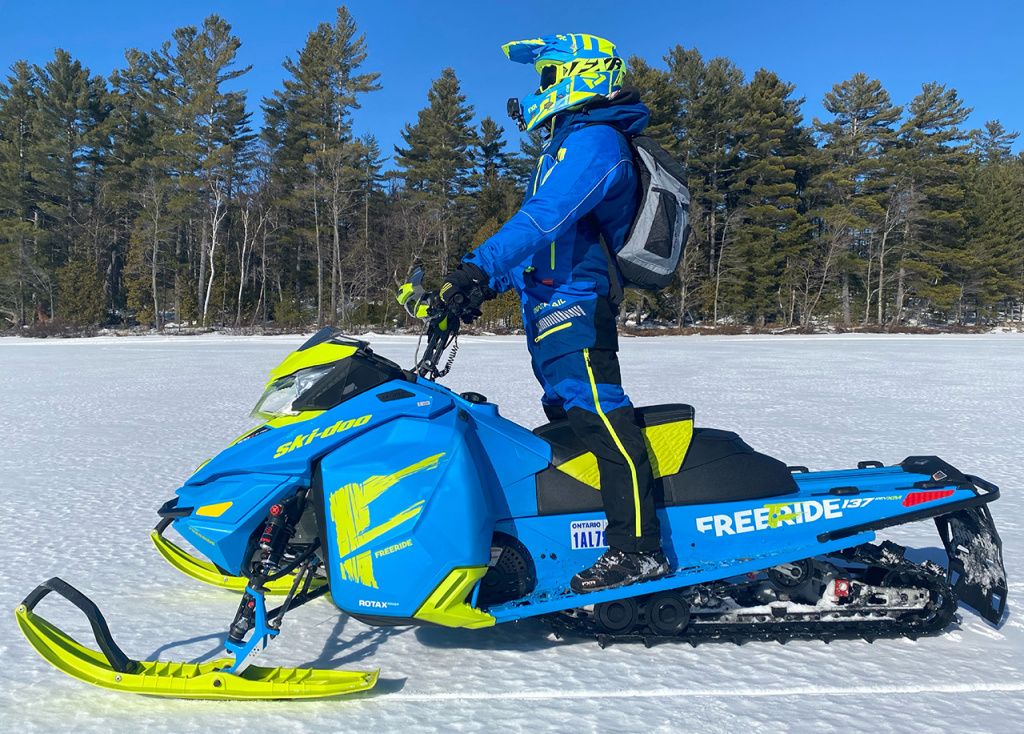 man on snowmobile monosuit